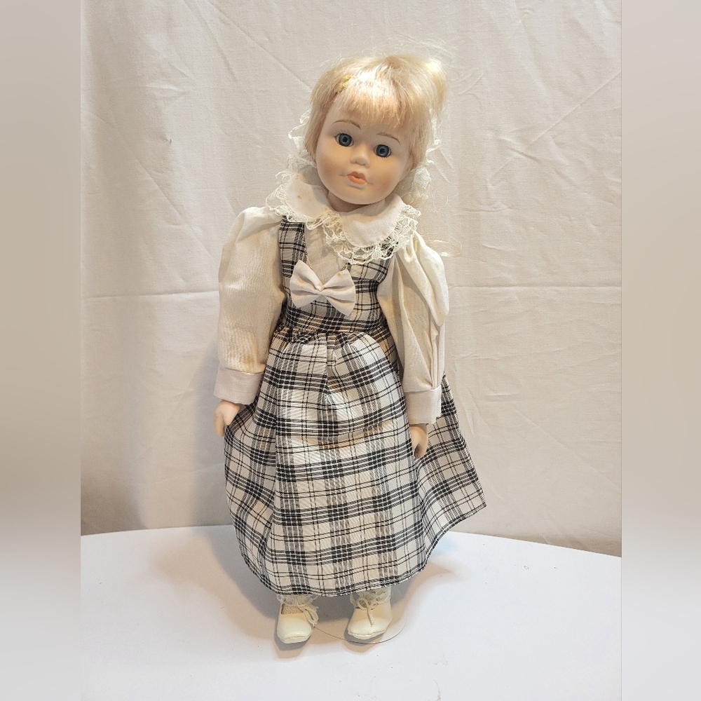 Vintage porcelain doll with stand